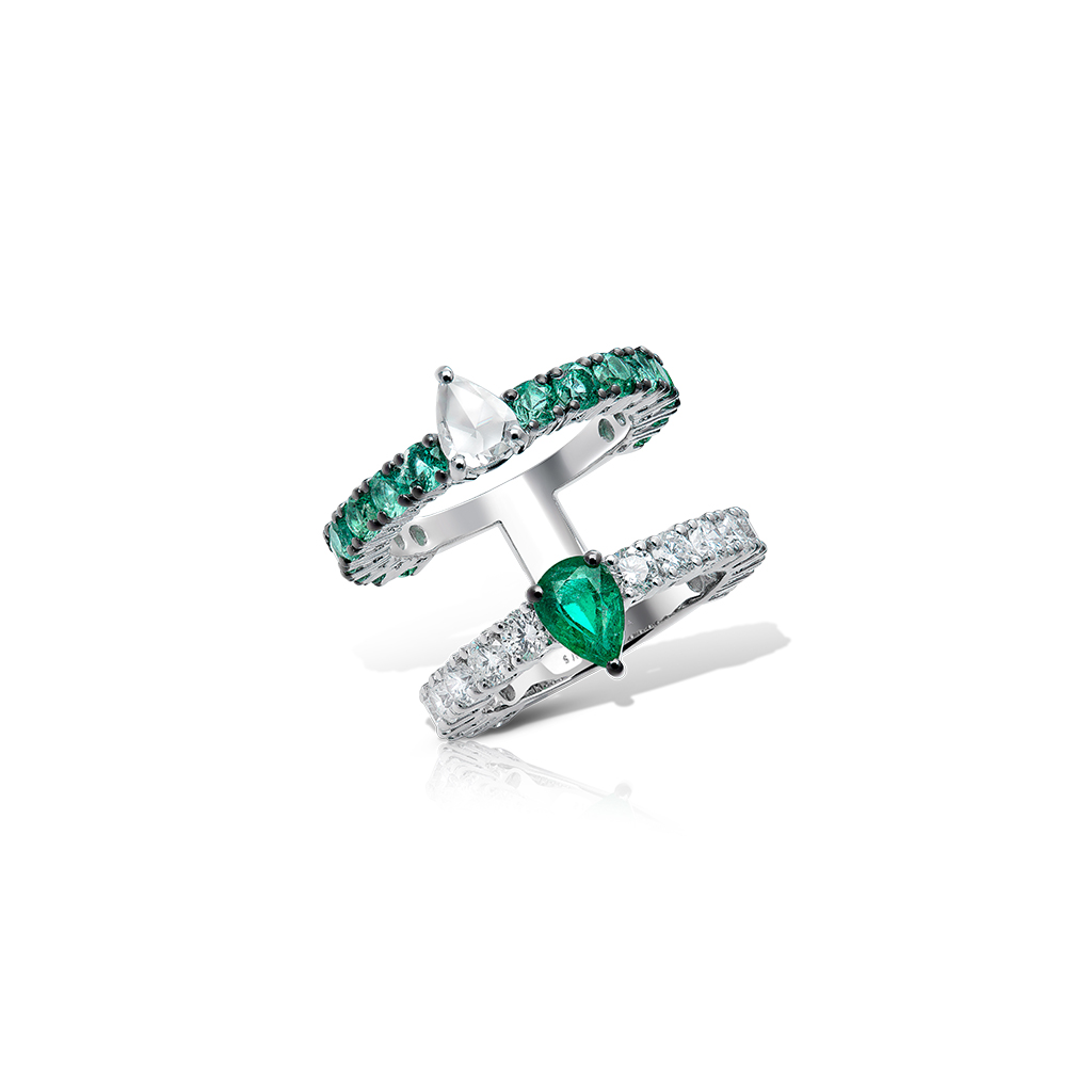 Double eternity ring featuring green and clear gemstones set in silver.