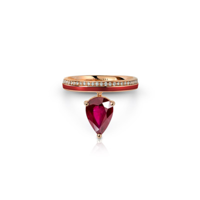 Ring featuring a pear-shaped ruby red gemstone set in a gold band with small diamonds.