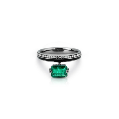 Emerald octagon ring with a black band and diamond accents on the top.