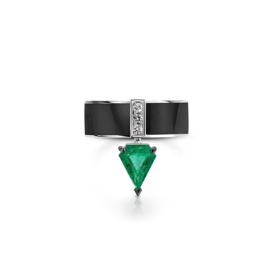 Ring featuring a kite cut emerald and diamond accents on a black band.