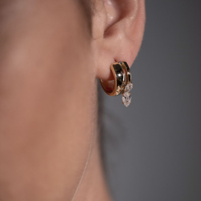 Gold hoop earrings featuring diamond accents, showcasing a stylish design suitable for various occasions.