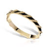 Color Therapy Tilted Barres Bangle in black with gold accents and diamond-like embellishments, showcasing a modern jewelry design.