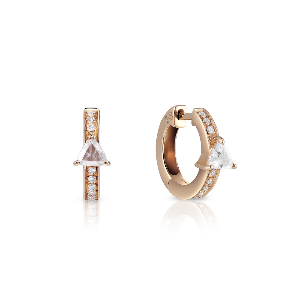 Gold ear huggies featuring a triangular diamond and small round diamonds along the band.