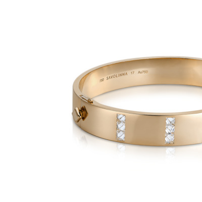 Gold bangle featuring diamond accents set in a sleek design with a polished finish.