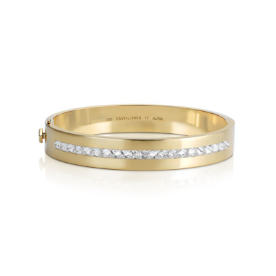 Yellow gold bangle featuring a single row of diamonds along the center.