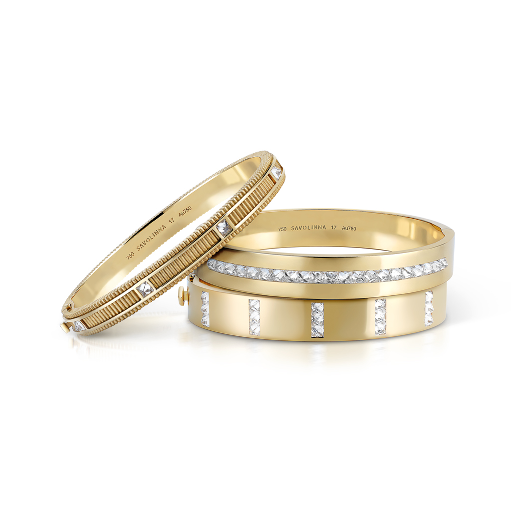 Two gold bangles featuring crystal accents and a smooth finish, displayed together.