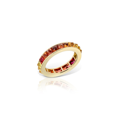 Gold eternity band featuring a single row of ombre sapphires in various colors.