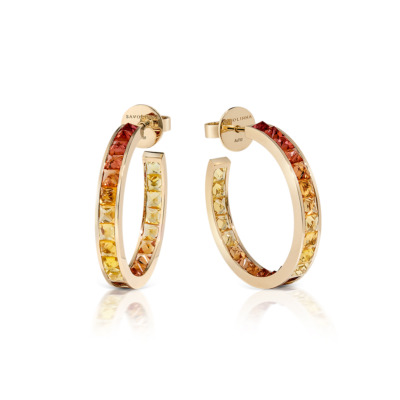 Gold hoop earrings featuring a single row of ombre sapphires in shades of yellow and orange.
