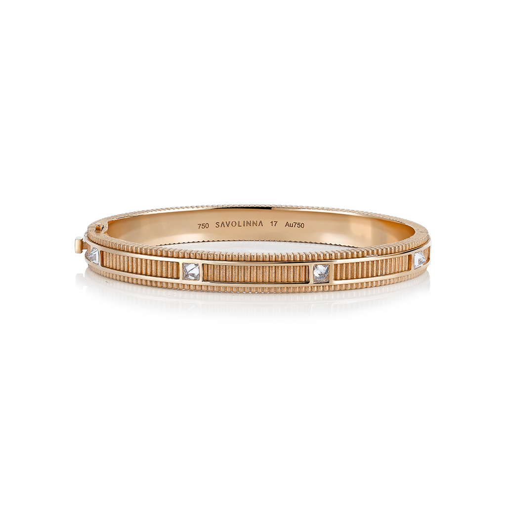 Matte gold bangle featuring diamond accents and a textured design.