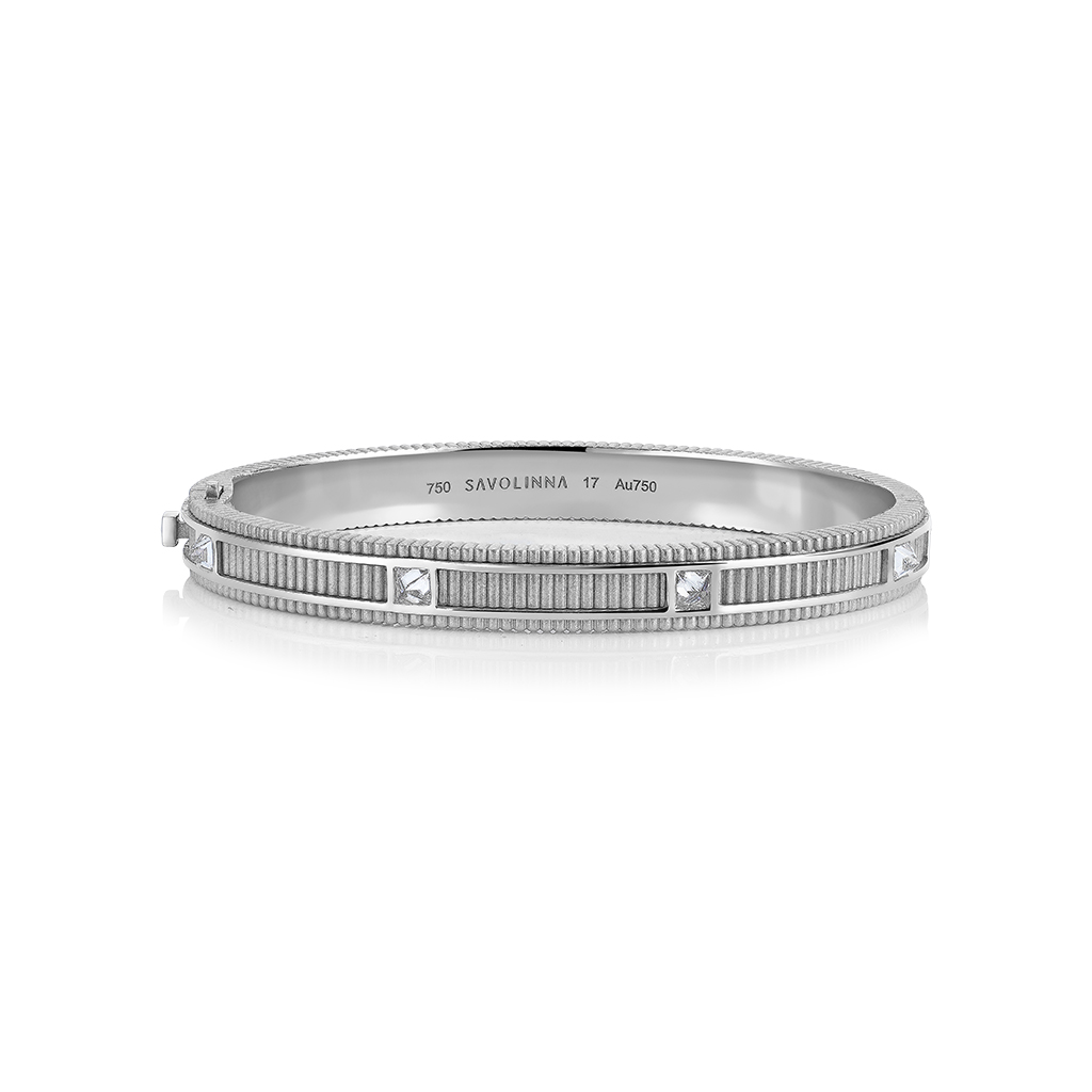 Matte white gold bangle with diamond accents and textured design.