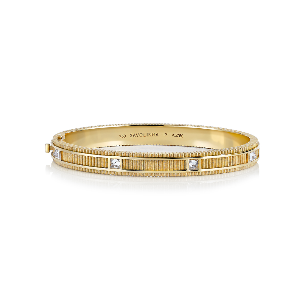 Gold matte bangle featuring diamond accents and a textured design.