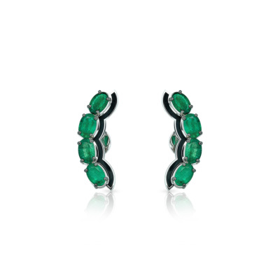Pair of oval emerald stud earrings set in silver with a curved design.