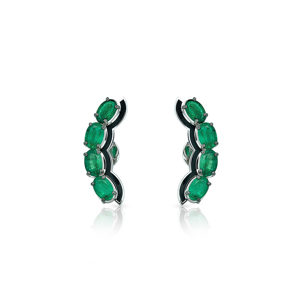 Pair of oval emerald stud earrings set in silver with a curved design.