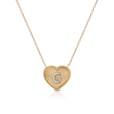 Gold heart-shaped pendant featuring the letter G and diamond accents on a chain.