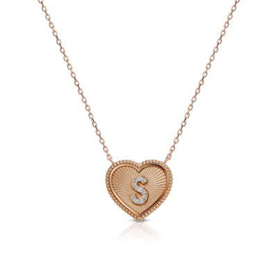 Mini heart-shaped pendant necklace featuring the letter S in the center, made of rose gold.