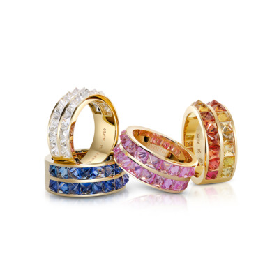 Four double row rings featuring colored stones in blue, pink, yellow, and clear designs.