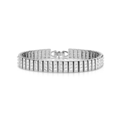 Three white gold bangles set with diamonds arranged in a row.