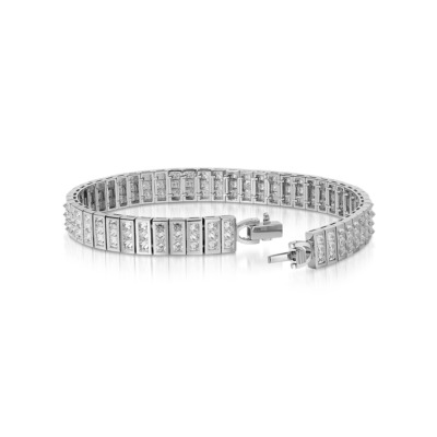 Three white gold bangles with diamond accents arranged in a row.