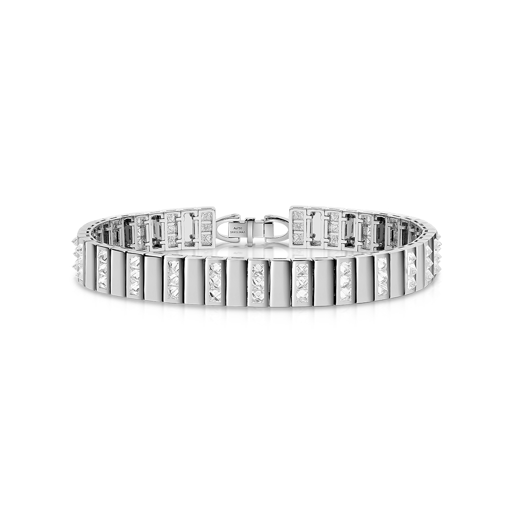 Silver bangle bracelet featuring alternating diamond accents in a spiked design.