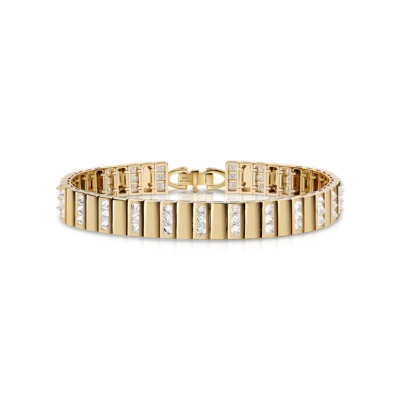 A trio of gold bangles with alternating diamond accents arranged in a row.
