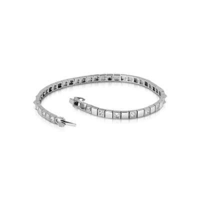 Slim tennis bracelet featuring alternating diamond and metal square links in white gold.