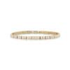 Slim tennis bracelet featuring square diamonds set in a yellow gold band.