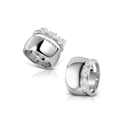 Two silver rings featuring three clear stones set in a row on the top band.