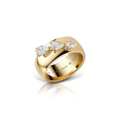 Gold ring featuring three pear-shaped diamonds set in a polished band.