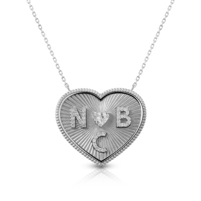 Silver heart-shaped necklace featuring the initials N, B, and C engraved on the surface.