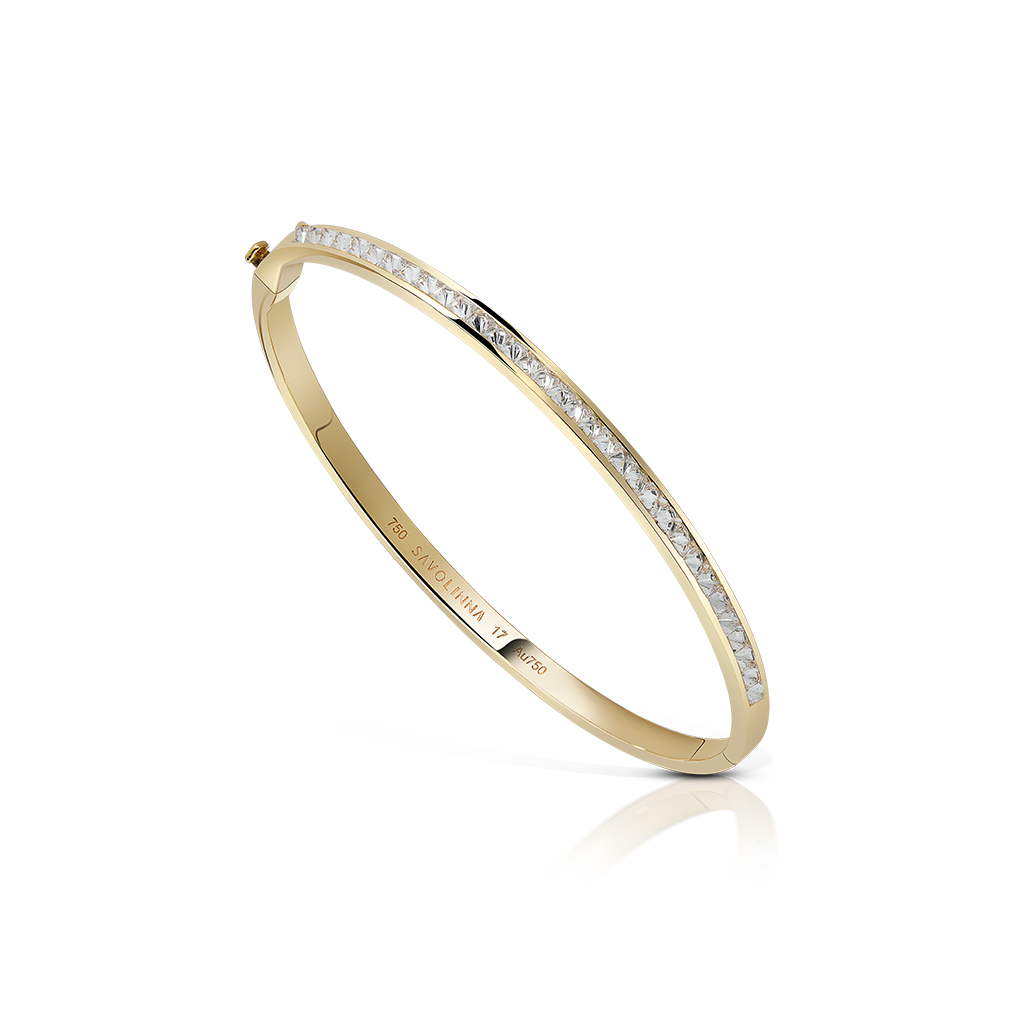 Extra slim bangle featuring a single row of diamonds set in yellow gold.
