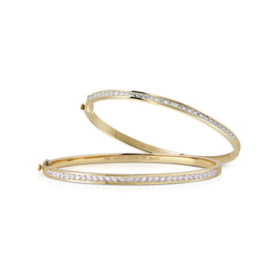 Two gold bangle bracelets featuring a single row of diamonds along the outer edge.