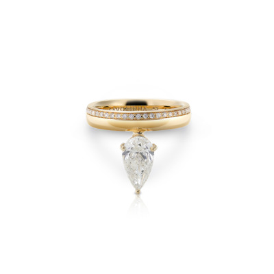 Yellow gold ring featuring a pear-shaped diamond and smaller diamonds on the band.