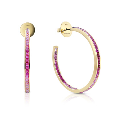 Gold hoop earrings featuring a single row of pink sapphires along the outer edge.