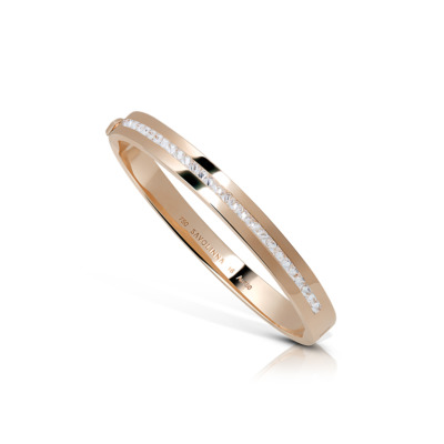 Slim gold bangle featuring a single row of clear stones along one side.
