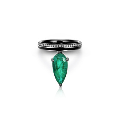 Ring featuring a marquise-cut emerald stone set in a black band with small white stones.
