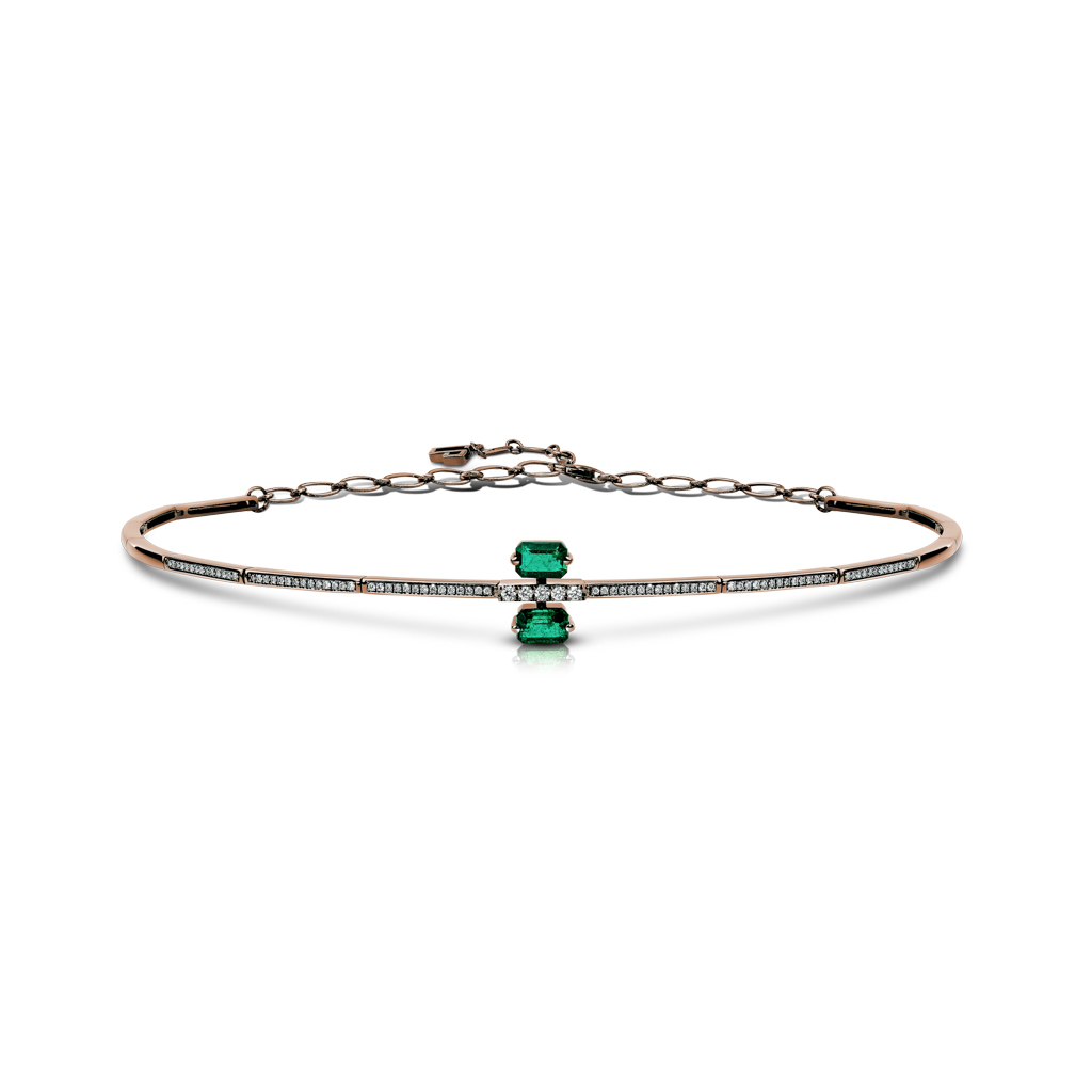 Choker necklace featuring double emerald stones and diamond accents on a gold band.