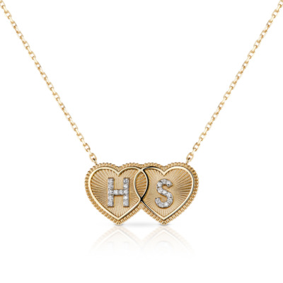 Gold double heart necklace featuring the initials HS and diamond accents.