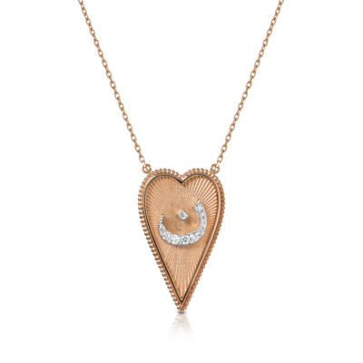Gold heart-shaped pendant necklace featuring a diamond accent in a crescent shape.