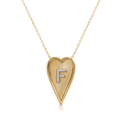 Elongated heart-shaped necklace in yellow gold featuring the letter F adorned with small diamonds.