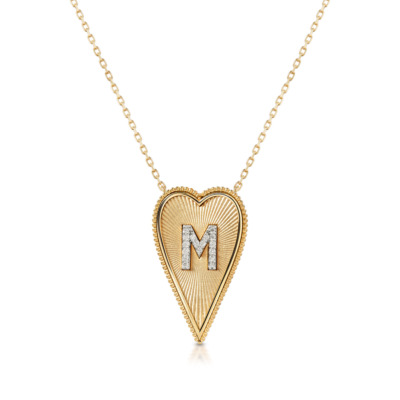 Gold elongated heart necklace featuring the letter M in a diamond-studded design.