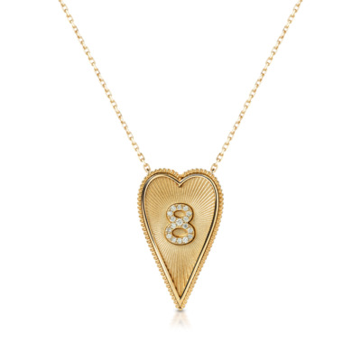 Elongated heart-shaped necklace featuring the number 8 in a gold setting with decorative accents.