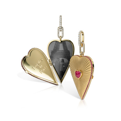 Elongated heart-shaped locket with ruby accents and a photo compartment featuring the Eiffel Tower.