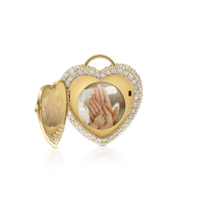 Gold heart-shaped locket with a diamond-encrusted border and an open compartment displaying hands inside.