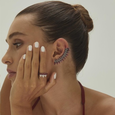Model showcasing a unique ear cuff and matching ring, highlighting intricate jewelry design and craftsmanship.