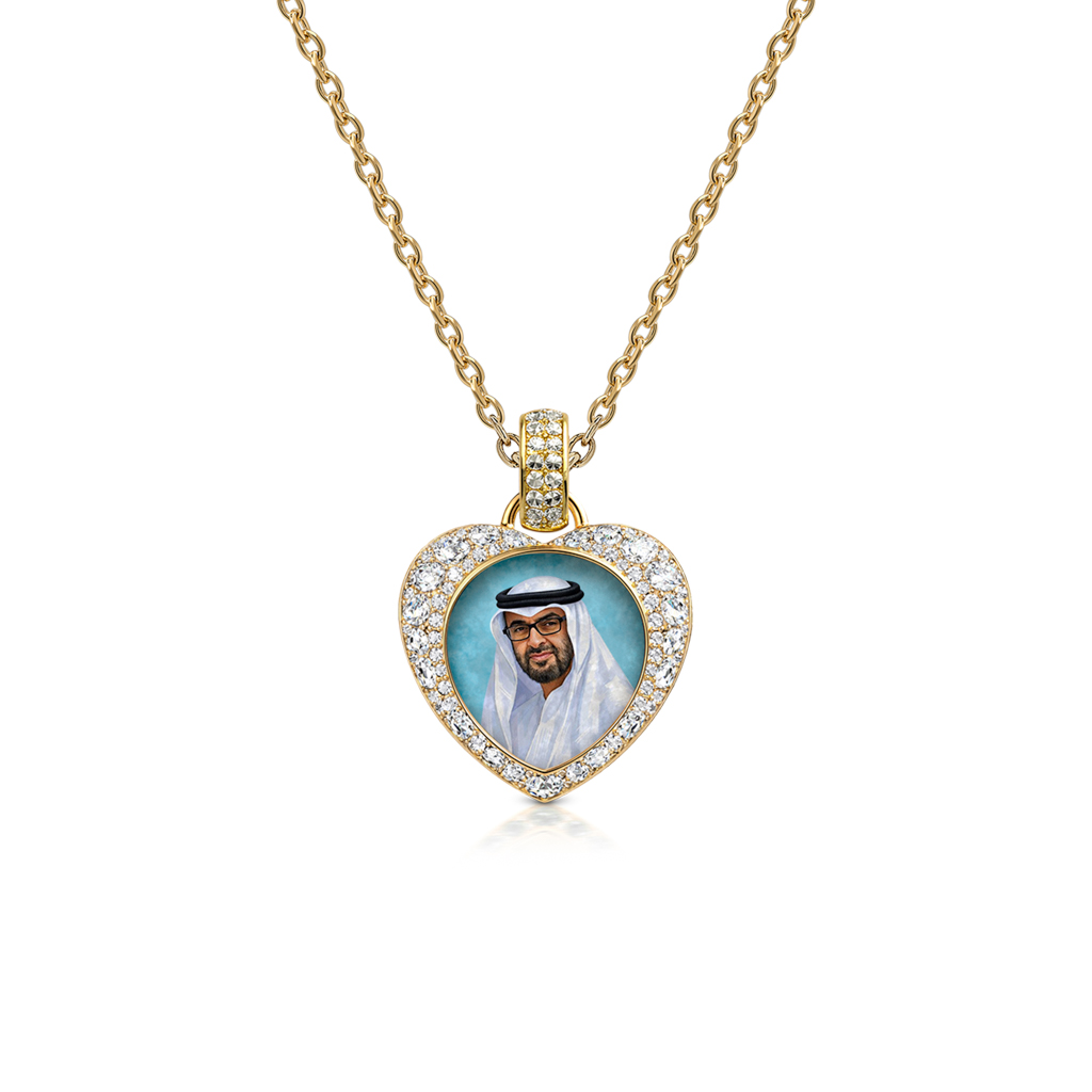 Heart of the Nation pendant in 18k gold, diamond pavé surround, featuring a finely rendered portrait of Sheikh Mohamed bin Zayed Al Nahyan set against a teal background