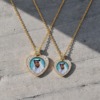 Gold heart-shaped pendant featuring a hand-painted portrait of Sheikh Mohamed bin Zayed Al Nahyan, surrounded by a halo of brilliant-cut diamonds on a gold chain