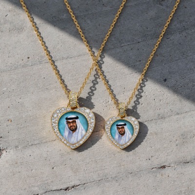 Gold heart-shaped pendant featuring a hand-painted portrait of Sheikh Mohamed bin Zayed Al Nahyan, surrounded by a halo of brilliant-cut diamonds on a gold chain