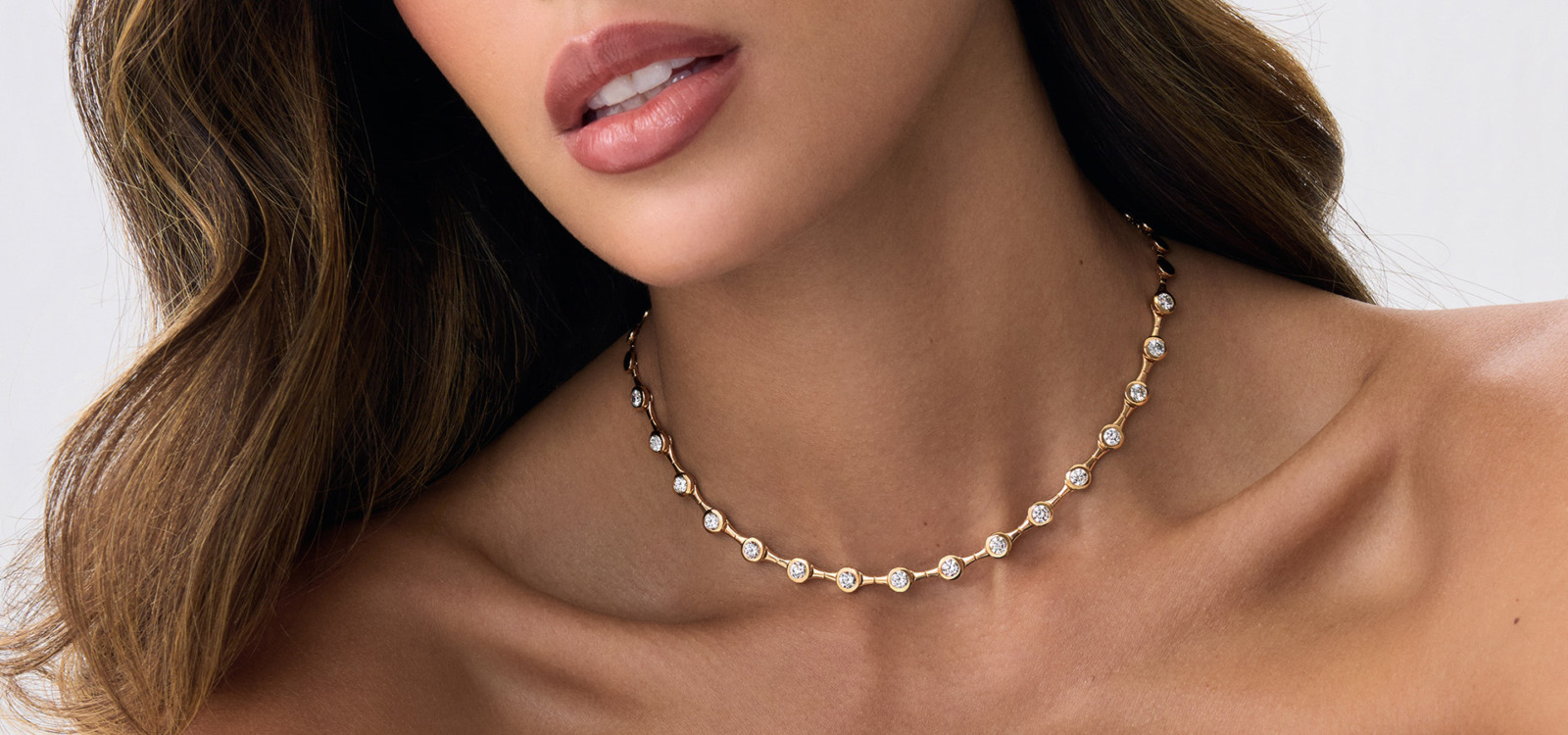 Savolinna gold necklace featuring round diamond accents set in a delicate linked chain, showcasing a luxurious diamond necklace aesthetic